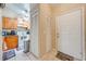Inviting entryway with tiled floor, kitchen view, and closet for coat and storage at 86 Pine Island Cir, Kissimmee, FL 34743