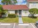 Charming front entrance features a walkway, red roof, landscaping, and inviting decor at 86 Pine Island Cir, Kissimmee, FL 34743