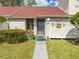 Charming front entrance features a walkway, red roof, landscaping, and inviting decor at 86 Pine Island Cir, Kissimmee, FL 34743