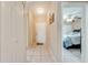 Hallway view showcasing tile flooring, closet space, and an entry leading to a bedroom at 86 Pine Island Cir, Kissimmee, FL 34743