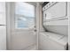 Laundry room featuring a stackable washer and dryer and access to the outside at 86 Pine Island Cir, Kissimmee, FL 34743