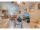 Open-concept living space with seating, a glass table, tile flooring, and dining room area view at 86 Pine Island Cir, Kissimmee, FL 34743