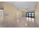 Large living room with tile floors, high ceilings, and sliding glass doors to the outdoors at 86 Pine Island Cir, Kissimmee, FL 34743