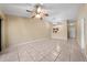 Open living room with tile flooring, neutral walls, ceiling fan, and passthrough to the kitchen at 86 Pine Island Cir, Kissimmee, FL 34743