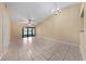 Bright living room with tile floors, neutral walls, ceiling fan, and sliding glass doors to the outside at 86 Pine Island Cir, Kissimmee, FL 34743