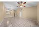Spacious living room featuring neutral walls, tile floors, and a classic ceiling fan with lighting at 86 Pine Island Cir, Kissimmee, FL 34743