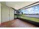 Screened porch with brick flooring, offering peaceful lake views at 86 Pine Island Cir, Kissimmee, FL 34743