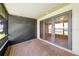Screened porch with brick flooring, glass doors leading indoors, and lake view at 86 Pine Island Cir, Kissimmee, FL 34743