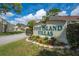 Pine Island Villas welcome sign with well-maintained landscaping at the entrance of the community at 86 Pine Island Cir, Kissimmee, FL 34743