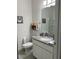Bathroom featuring granite countertop, under sink cabinets, and a shower at 9690 Emerald Berry Dr, Winter Garden, FL 34787