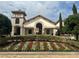 View of a clubhouse with stone accents and manicured landscaping at 9690 Emerald Berry Dr, Winter Garden, FL 34787