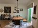 Dining area with ample lighting and a doorway leading to the kitchen and outdoor space at 9690 Emerald Berry Dr, Winter Garden, FL 34787