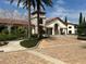 Stunning exterior view of clubhouse featuring stone accents, arched entrance and meticulously landscaped surroundings at 9690 Emerald Berry Dr, Winter Garden, FL 34787