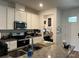 Kitchen area with modern appliances and a view of the door to the office area at 9690 Emerald Berry Dr, Winter Garden, FL 34787