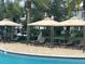 Relaxing poolside cabanas with lounge chairs, perfect for enjoying the sun and shade in a private outdoor retreat at 9690 Emerald Berry Dr, Winter Garden, FL 34787