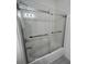 Bathroom bathtub-shower combination with glass doors at 9690 Emerald Berry Dr, Winter Garden, FL 34787