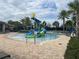 Community water park featuring a colorful water slide, a splash pad, and resort-style pool with ample lounge seating at 9690 Emerald Berry Dr, Winter Garden, FL 34787