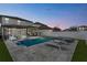 Backyard view showcases a pool, jacuzzi, patio and lounging area with nice fencing at dusk at 9811 Aurea Moss Ln, Orlando, FL 32832