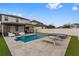 Backyard view showcases a pool, jacuzzi, patio and lounging area with nice fencing at 9811 Aurea Moss Ln, Orlando, FL 32832