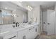 Elegant bathroom with double sinks, modern fixtures, and a large mirror at 9811 Aurea Moss Ln, Orlando, FL 32832