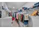 Walk-in closet with organized shelving, rods, and storage for clothing and accessories at 9811 Aurea Moss Ln, Orlando, FL 32832