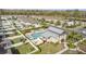 Stunning aerial view of community pool area with modern design, lounge seating, and immaculate landscaping at 9811 Aurea Moss Ln, Orlando, FL 32832