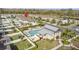 Breathtaking aerial view of a community pool area with modern design, inviting lounge seating, and beautiful landscaping at 9811 Aurea Moss Ln, Orlando, FL 32832