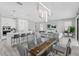 Bright and open dining area with a modern table setting, stylish lighting, and seamless flow to the kitchen at 9811 Aurea Moss Ln, Orlando, FL 32832