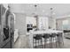 Modern kitchen with stainless steel appliances, a spacious island, and comfortable seating at the breakfast bar at 9811 Aurea Moss Ln, Orlando, FL 32832