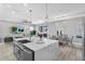 Open-concept design with a large kitchen island, modern faucet, and seamless flow to the living and dining areas at 9811 Aurea Moss Ln, Orlando, FL 32832