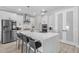 Elegant kitchen with stainless steel appliances, quartz countertops, a breakfast bar, and ample cabinet space at 9811 Aurea Moss Ln, Orlando, FL 32832
