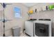 Functional laundry room with modern appliances and a convenient storage rack and shelving at 9811 Aurea Moss Ln, Orlando, FL 32832