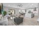 Bright, open-concept living room featuring a modern ceiling fan, and sliding glass doors to a backyard pool at 9811 Aurea Moss Ln, Orlando, FL 32832