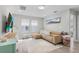 Bright living room featuring a comfortable sectional, modern entertainment center, and stylish decor for relaxation at 9811 Aurea Moss Ln, Orlando, FL 32832