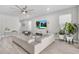 Inviting living area with a large sectional sofa, stylish decor, and seamless flow to other living spaces at 9811 Aurea Moss Ln, Orlando, FL 32832