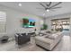 Comfortable living room showcases modern decor, a large screen TV, and seamless access to the backyard at 9811 Aurea Moss Ln, Orlando, FL 32832