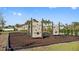 Community playground with slides, climbing structures, and lush landscaping on a sunny day at 9811 Aurea Moss Ln, Orlando, FL 32832