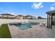 Backyard features a swimming pool, jacuzzi and lounge chairs, with artificial turf for easy maintenance at 9811 Aurea Moss Ln, Orlando, FL 32832