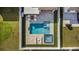 Overhead view of backyard pool with a spa, lounge chairs, and contemporary patio in a private backyard at 9811 Aurea Moss Ln, Orlando, FL 32832