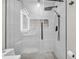 Modern shower with rainfall showerhead, glass door, and built-in niche for toiletries at 9811 Aurea Moss Ln, Orlando, FL 32832