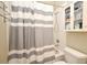 Bathroom showcasing a shower and tub combination with a striped curtain and built-in storage shelves at 1027 Banks Rose St, Celebration, FL 34747