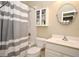 Bathroom featuring a shower-tub, vanity with sink, toilet, mirror, and storage cabinet at 1027 Banks Rose St, Celebration, FL 34747