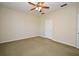 Neutral carpeted bedroom with ceiling fan and closet, creating a cozy atmosphere at 1027 Banks Rose St, Celebration, FL 34747