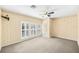 Spacious bedroom with neutral carpet, fan, and three shuttered windows for ample natural light at 1027 Banks Rose St, Celebration, FL 34747