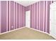 Unique bedroom featuring vertical striped paint, neutral carpet, and a standard closet door at 1027 Banks Rose St, Celebration, FL 34747
