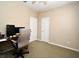 A bedroom with blue accent wall, neutral walls, carpeted floors, and two doors at 1027 Banks Rose St, Celebration, FL 34747