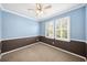 Inviting bedroom with blue and brown walls, carpet, and shuttered windows at 1027 Banks Rose St, Celebration, FL 34747
