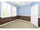 Bedroom featuring two-tone paint, neutral carpet, and bright natural light from two shuttered windows at 1027 Banks Rose St, Celebration, FL 34747