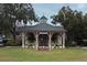 Community clubhouse with a fountain feature, seating, and mature landscaping at 1027 Banks Rose St, Celebration, FL 34747