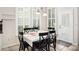 Bright dining area with large windows, plantation shutters, and an adjacent door at 1027 Banks Rose St, Celebration, FL 34747